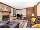 Comfortable living room with a brick fireplace and leather sofas at 108 Birdie Ct, Rocky Mount, NC 27804