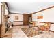 This cozy living room features neutral walls, a brick fireplace, and tile flooring at 108 Birdie Ct, Rocky Mount, NC 27804