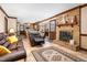 Open living space showcasing a brick fireplace and cozy seating area adjacent to kitchen at 108 Birdie Ct, Rocky Mount, NC 27804