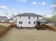 Large backyard with a wood fence, patio, and manicured lawn at 111 Kim Bark Path, Garner, NC 27529