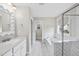 Bright bathroom features a separate tub and shower with designer tile and updated fixtures at 111 Kim Bark Path, Garner, NC 27529