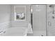 Stylish bathroom offers a separate tub and shower with white herringbone tiling at 111 Kim Bark Path, Garner, NC 27529