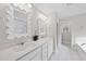 Elegant bathroom boasts dual sinks, white cabinetry, decorative mirrors and updated fixtures at 111 Kim Bark Path, Garner, NC 27529