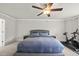 Spacious bedroom featuring plush carpet, ceiling fan, natural light, and exercise equipment at 111 Kim Bark Path, Garner, NC 27529