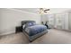 Spacious bedroom featuring plush carpet, ceiling fan, natural light, and exercise equipment at 111 Kim Bark Path, Garner, NC 27529