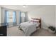 Comfortable bedroom with ample natural light, soft carpet, and a cozy bed at 111 Kim Bark Path, Garner, NC 27529