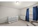 Cozy bedroom featuring soft carpet, natural light, and a white baby crib at 111 Kim Bark Path, Garner, NC 27529