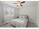 Cozy bedroom featuring a ceiling fan, neutral tones and large window at 111 Kim Bark Path, Garner, NC 27529