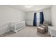 Cozy bedroom featuring soft carpet, natural light, and a white baby crib at 111 Kim Bark Path, Garner, NC 27529