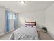 Comfortable bedroom with ample natural light, soft carpet, and a cozy bed at 111 Kim Bark Path, Garner, NC 27529