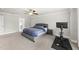 Bright bedroom featuring a plush carpet, neutral paint, ceiling fan, and ensuite bath access at 111 Kim Bark Path, Garner, NC 27529
