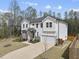 Charming two-story home boasts white siding, stone accents, well-manicured landscaping, and an attached two-car garage at 111 Kim Bark Path, Garner, NC 27529
