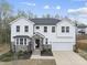 Charming two-story home boasts white siding, stone accents, well-manicured landscaping, and an attached two-car garage at 111 Kim Bark Path, Garner, NC 27529