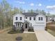 Charming two-story home boasts white siding, stone accents, well-manicured landscaping, and an attached two-car garage at 111 Kim Bark Path, Garner, NC 27529