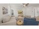 Bright living room with modern ceiling fan and plenty of natural light at 111 Kim Bark Path, Garner, NC 27529