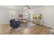 Cozy living room features hardwood floors, neutral paint, a ceiling fan, a comfortable sofa, and natural light at 111 Kim Bark Path, Garner, NC 27529