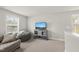 Well-lit bonus room with a mounted television and cozy seating at 111 Kim Bark Path, Garner, NC 27529
