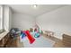 Spacious playroom with hardwood floors, ample natural light, built-in shelving, and a variety of play equipment at 111 Kim Bark Path, Garner, NC 27529