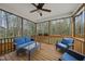 Cozy screened porch featuring a ceiling fan, ample seating, and a view of the backyard at 111 Kim Bark Path, Garner, NC 27529