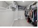 Walk-in closet features built-in shelving and hanging rods for optimal organization at 111 Kim Bark Path, Garner, NC 27529