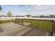 Wooden deck with railings overlooking a backyard with green grass and fence at 114 Hudson Dr, Princeton, NC 27569
