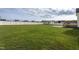 Expansive backyard with green grass, a shed, patio, and white fence at 114 Hudson Dr, Princeton, NC 27569