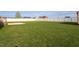 Wide open backyard with green grass, patio, privacy fence and a shed at 114 Hudson Dr, Princeton, NC 27569