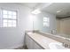 Bathroom featuring double sink vanity, large mirror, and natural light at 114 Hudson Dr, Princeton, NC 27569