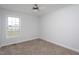 Carpeted bedroom with a ceiling fan and window at 114 Hudson Dr, Princeton, NC 27569