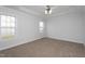 Carpeted bedroom with tray ceiling, ceiling fan and natural light at 114 Hudson Dr, Princeton, NC 27569