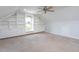 Attic bonus room featuring built-in shelving, ceiling fan, and window at 114 Hudson Dr, Princeton, NC 27569