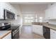 Bright kitchen with stainless steel appliances, white cabinets, and tile floors at 114 Hudson Dr, Princeton, NC 27569