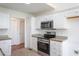 Modern kitchen with stainless steel appliances, white cabinets, and ample counter space at 114 Hudson Dr, Princeton, NC 27569