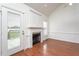 Bright living room with hardwood floors, fireplace, built-in cabinets, and access to outdoor deck at 114 Hudson Dr, Princeton, NC 27569