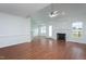 Spacious living room with hardwood floors connects to dining area and features a cozy fireplace at 114 Hudson Dr, Princeton, NC 27569