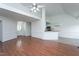 Bright, open-concept living room with hardwood floors connects to the kitchen and front entrance at 114 Hudson Dr, Princeton, NC 27569