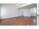 Open living room with hardwood floors and access to kitchen and front door at 114 Hudson Dr, Princeton, NC 27569