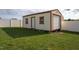 Outdoor shed with a roll up garage door, access door and two windows at 114 Hudson Dr, Princeton, NC 27569