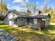 Backyard view shows the home's deck and exterior, complemented by rock landscaping at 11404 Leesville Rd, Raleigh, NC 27613