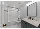 Updated bathroom showcasing modern fixtures, vanity with marble top, and a bathtub with shower at 11404 Leesville Rd, Raleigh, NC 27613