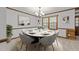 This decorated dining area features a marble table, gray chairs, and neutral carpet at 11404 Leesville Rd, Raleigh, NC 27613