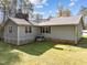 Exterior view of the home, showing the backyard and the home's siding and windows at 11404 Leesville Rd, Raleigh, NC 27613