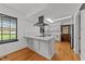 This kitchen features an island with bar stool seating, stainless appliances, and wood floors at 11404 Leesville Rd, Raleigh, NC 27613