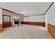 The living room features carpeted floors, wood-paneled walls, and a brick fireplace at 11404 Leesville Rd, Raleigh, NC 27613