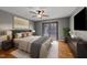 Comfortable main bedroom featuring modern decor, stylish furniture, and a sliding glass door to the deck at 11404 Leesville Rd, Raleigh, NC 27613