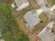 An aerial view of a well-maintained home with a fenced backyard and mature trees, nestled in a neighborhood at 120 Wellspring Dr, Holly Springs, NC 27540