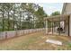 A spacious fenced-in backyard and covered patio, perfect for entertaining and enjoying outdoor living at 120 Wellspring Dr, Holly Springs, NC 27540
