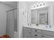 Bright bathroom featuring a double vanity, framed mirror, and a shower with curtain at 120 Wellspring Dr, Holly Springs, NC 27540