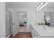 Bathroom with double sinks, walk-in shower and view to main bedroom at 120 Wellspring Dr, Holly Springs, NC 27540