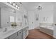 Bright bathroom with double vanity, stylish lighting, and soaking tub at 120 Wellspring Dr, Holly Springs, NC 27540